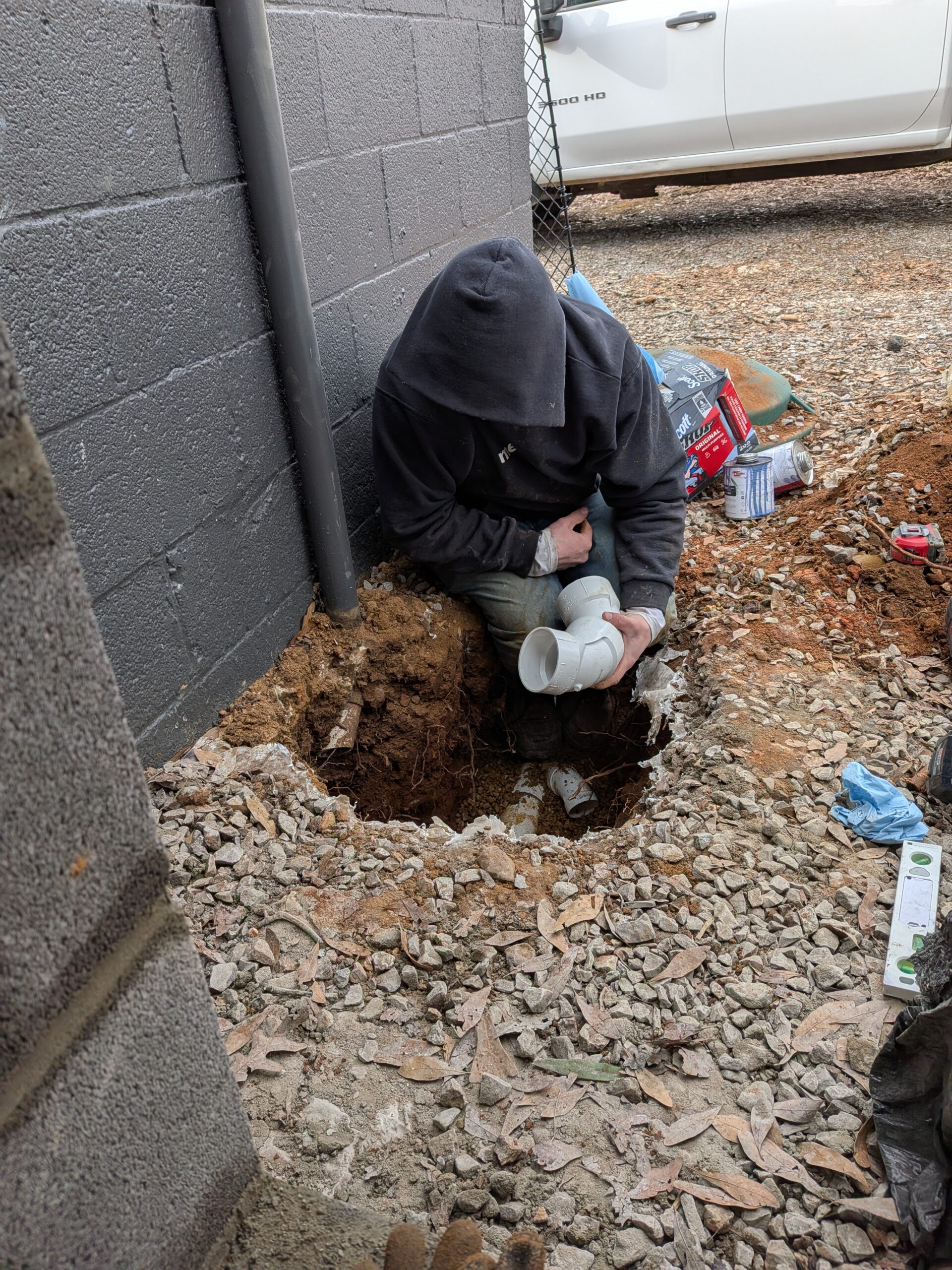 Piper's Plumbing specialist performing an underground sewer line repair and pipe fitting in Chattanooga TN