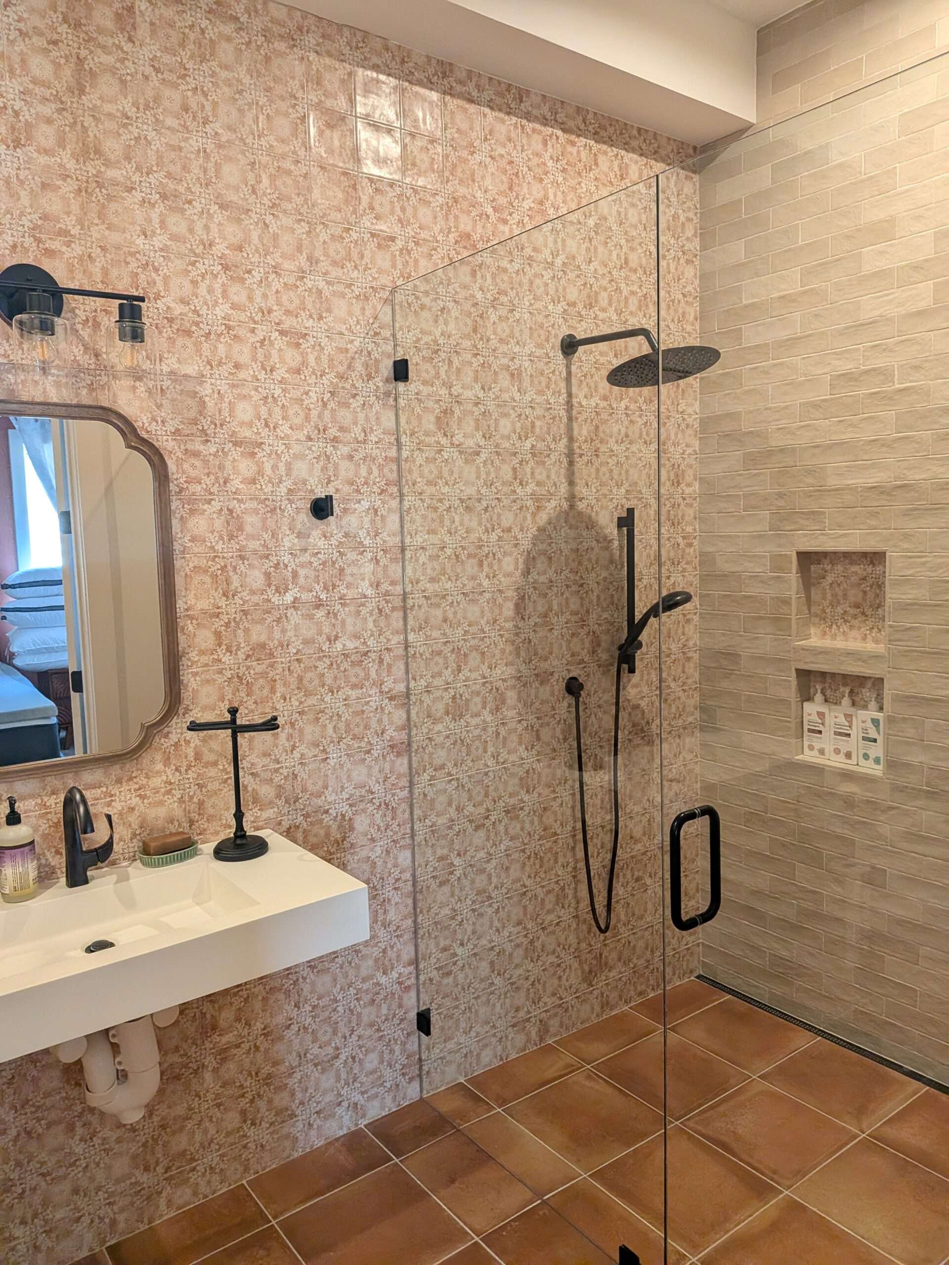 A modern bathroom remodel featuring custom tile work and a glass shower enclosure installed by plumbers in Dayton, TN